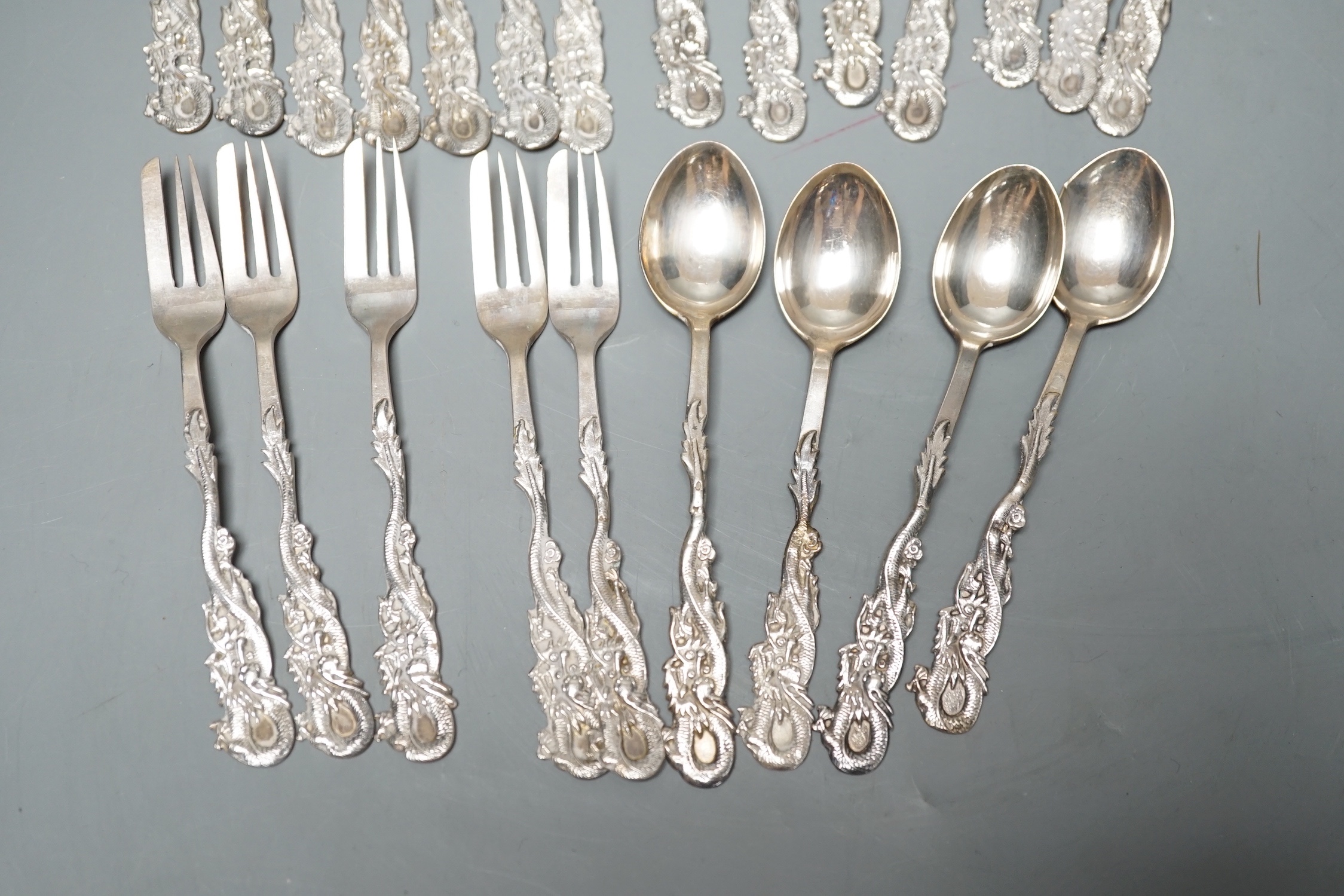 A set of twelve Chinese sterling tea forks, with dragon handles by YCCo and eleven similar teaspoons, 8oz.